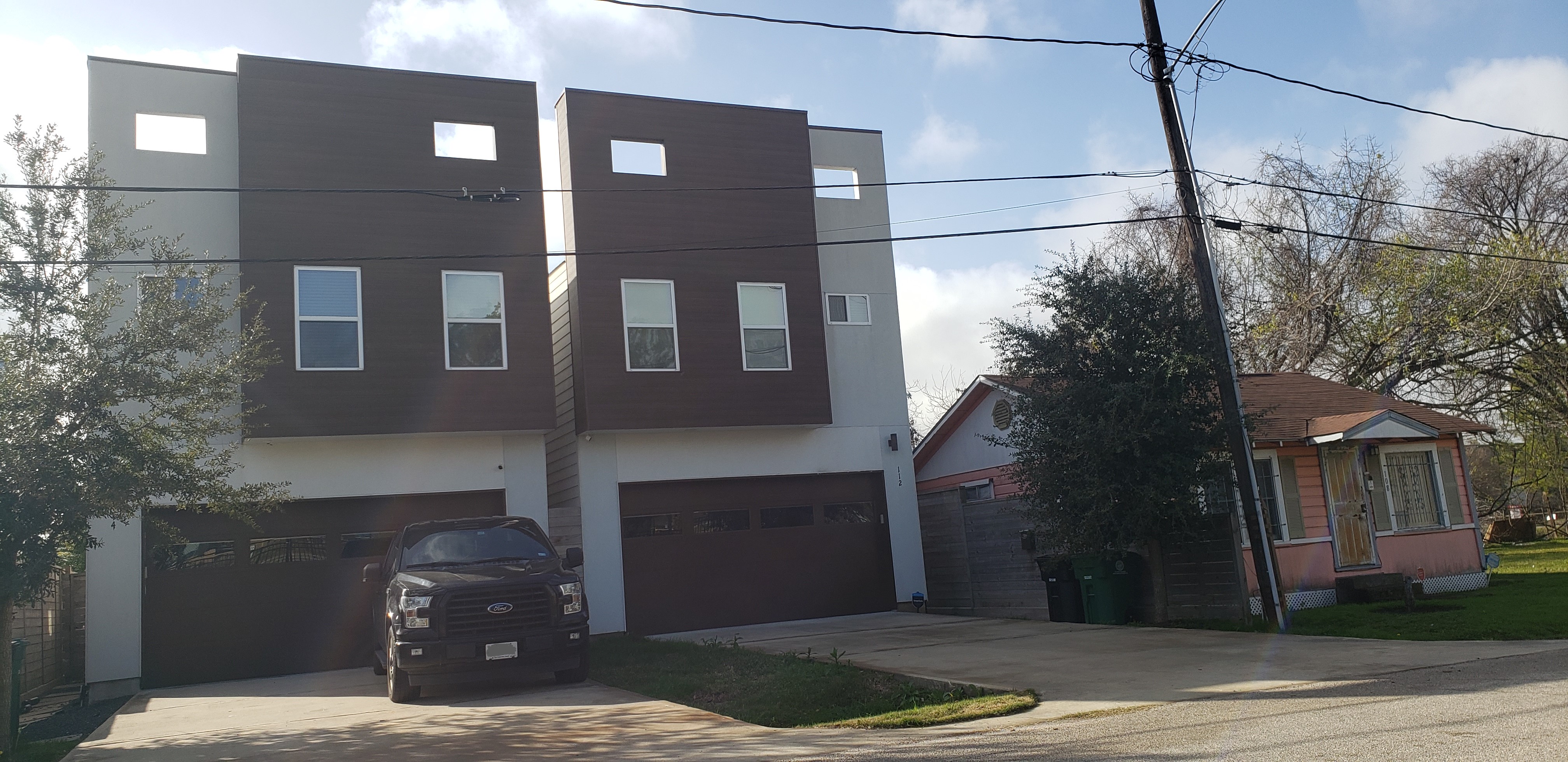 New duplex beside older house showing redevelopment opportunity