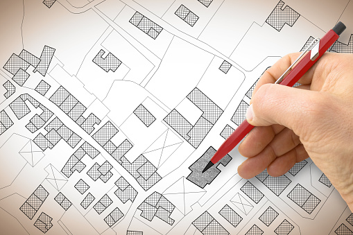 Development site plan being reviewed with pencil